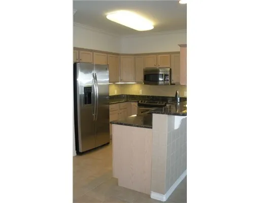 a kitchen with a refrigerator and cabinets