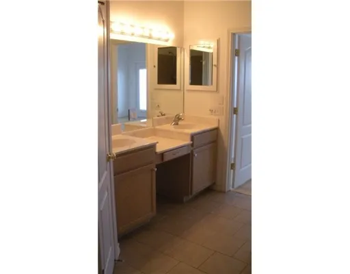 a en suite bathroom with a sink and mirror