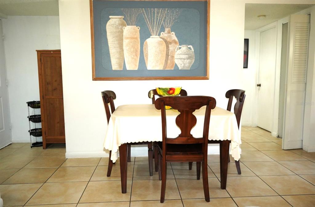 1664 Sunny Brook Lane, Unit 103 Palm Bay, FL 32905 - Photo 4 of 10 a view of a dining room with furniture and wooden floor