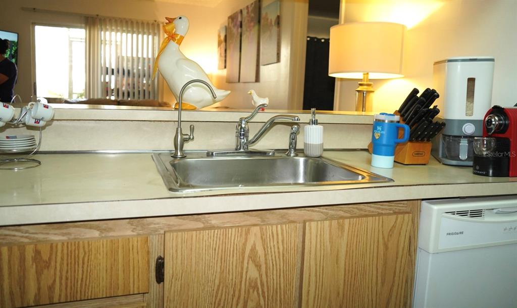 1664 Sunny Brook Lane, Unit 103 Palm Bay, FL 32905 - Photo 5 of 10 a kitchen with a sink and a window