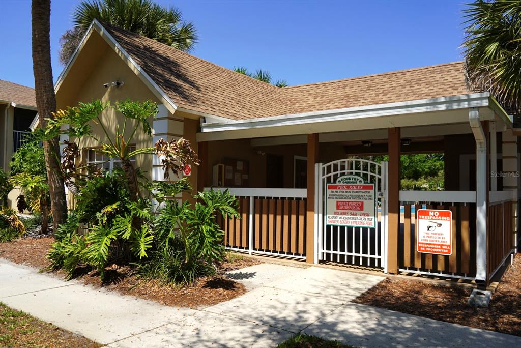 1664 Sunny Brook Lane, Unit 103 Palm Bay, FL 32905 - Photo 8 of 10 a view of a house with a small yard and plants