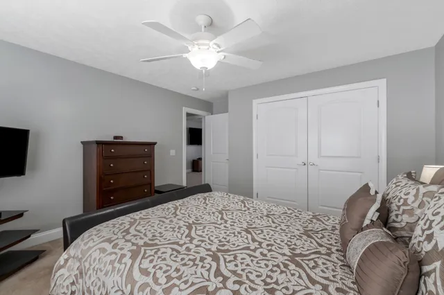 a bedroom with a bed and a television