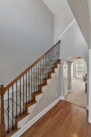 a view of a hallway with wooden floor and windows