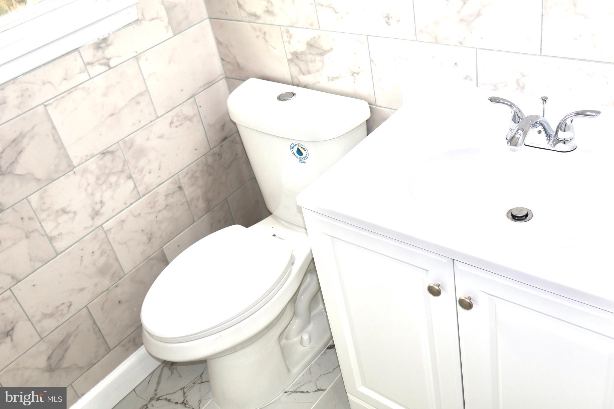 147 Deacon Road Fredericksburg, VA 22405 - Photo 29 of 97 a white toilet sitting next to a bathroom sink