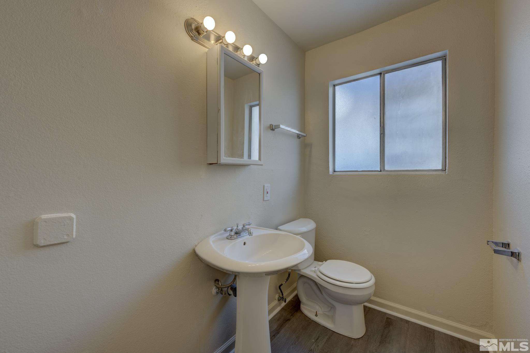 3431 Gypsum Road Reno, NV 89503 - Photo 7 of 13 a bathroom with a toilet sink and mirror