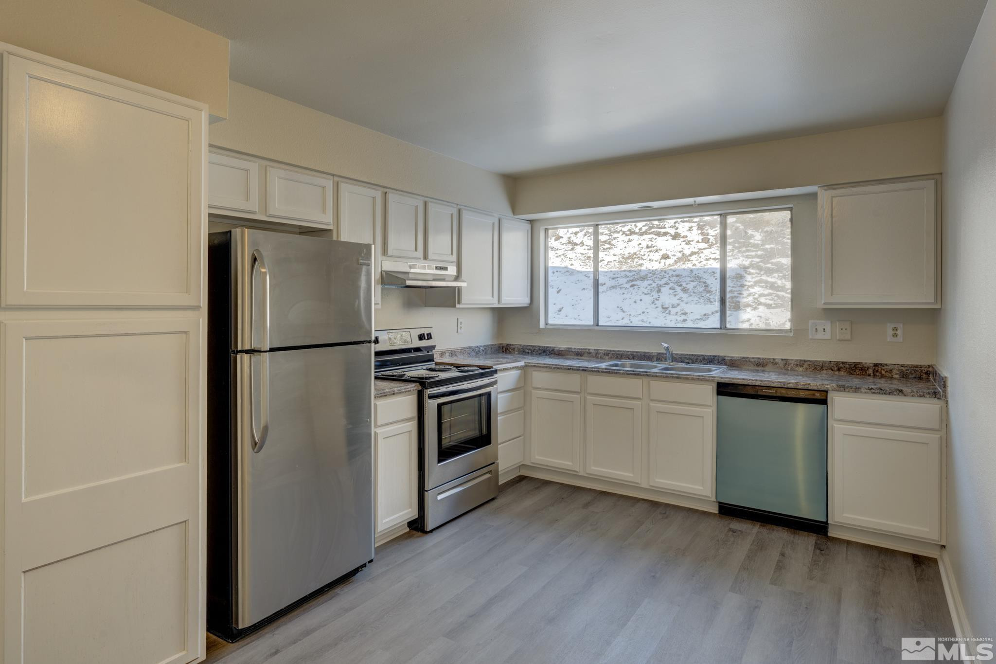 3431 Gypsum Road Reno, NV 89503 - Photo 8 of 13 a kitchen with granite countertop appliances a sink cabinets and a window