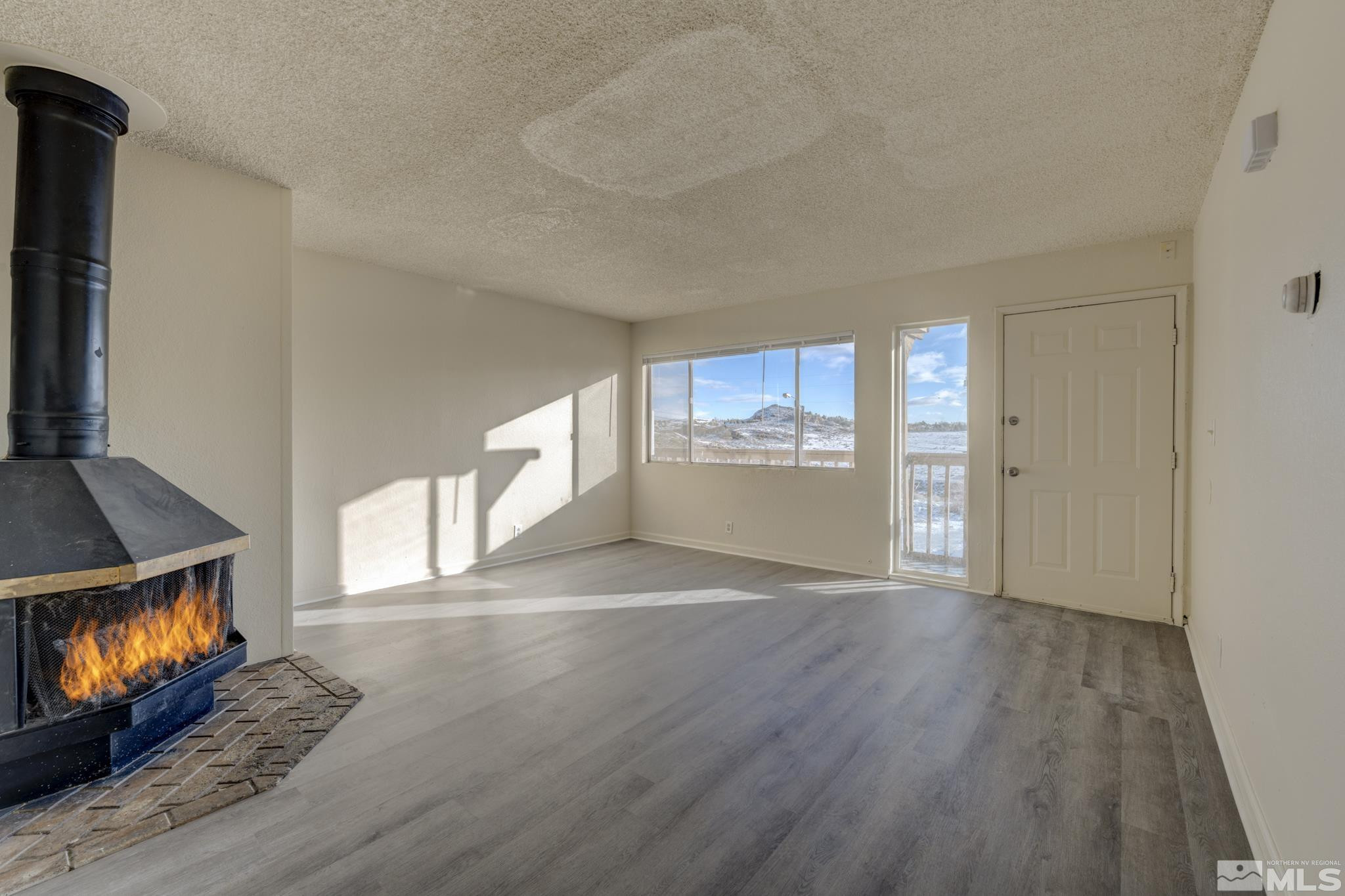 3431 Gypsum Road Reno, NV 89503 - Photo 9 of 13 a view of an empty room with wooden floor and a window