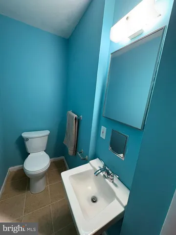 a bathroom with a sink toilet and mirror