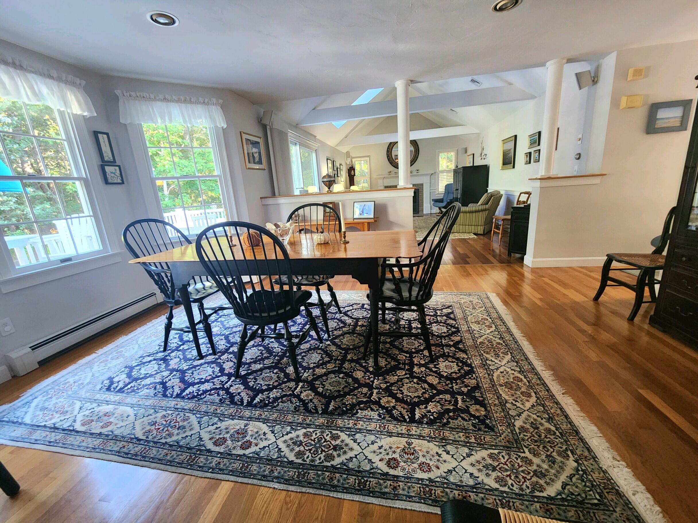 155 Far Fields Road Brewster, MA 02631 - Photo 12 of 40 a view of a dining room with furniture window and wooden floor