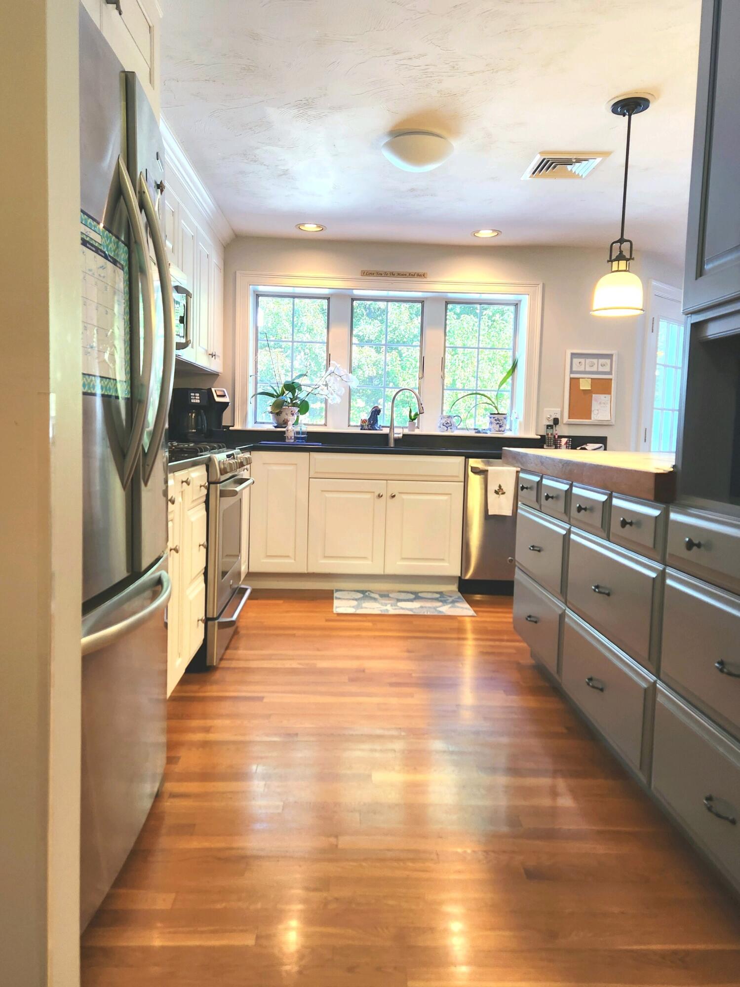 155 Far Fields Road Brewster, MA 02631 - Photo 13 of 40 a large kitchen with stainless steel appliances wooden floor and a large window