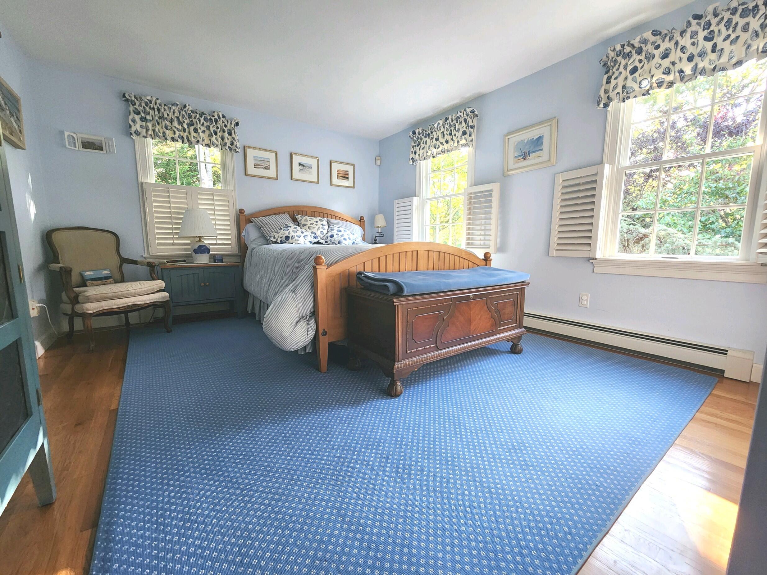 155 Far Fields Road Brewster, MA 02631 - Photo 20 of 40 a spacious bedroom with a bed and a large window
