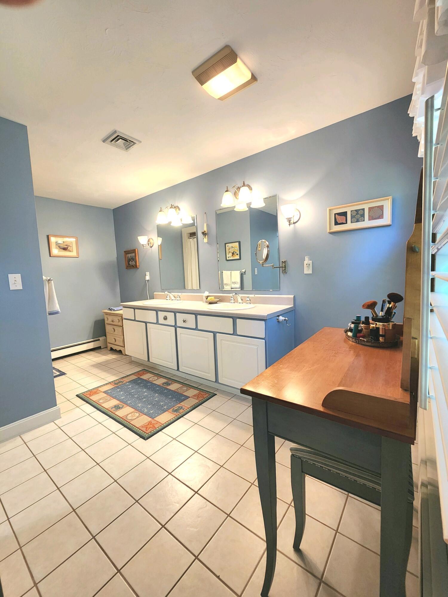 155 Far Fields Road Brewster, MA 02631 - Photo 22 of 40 a large kitchen with a table and chairs