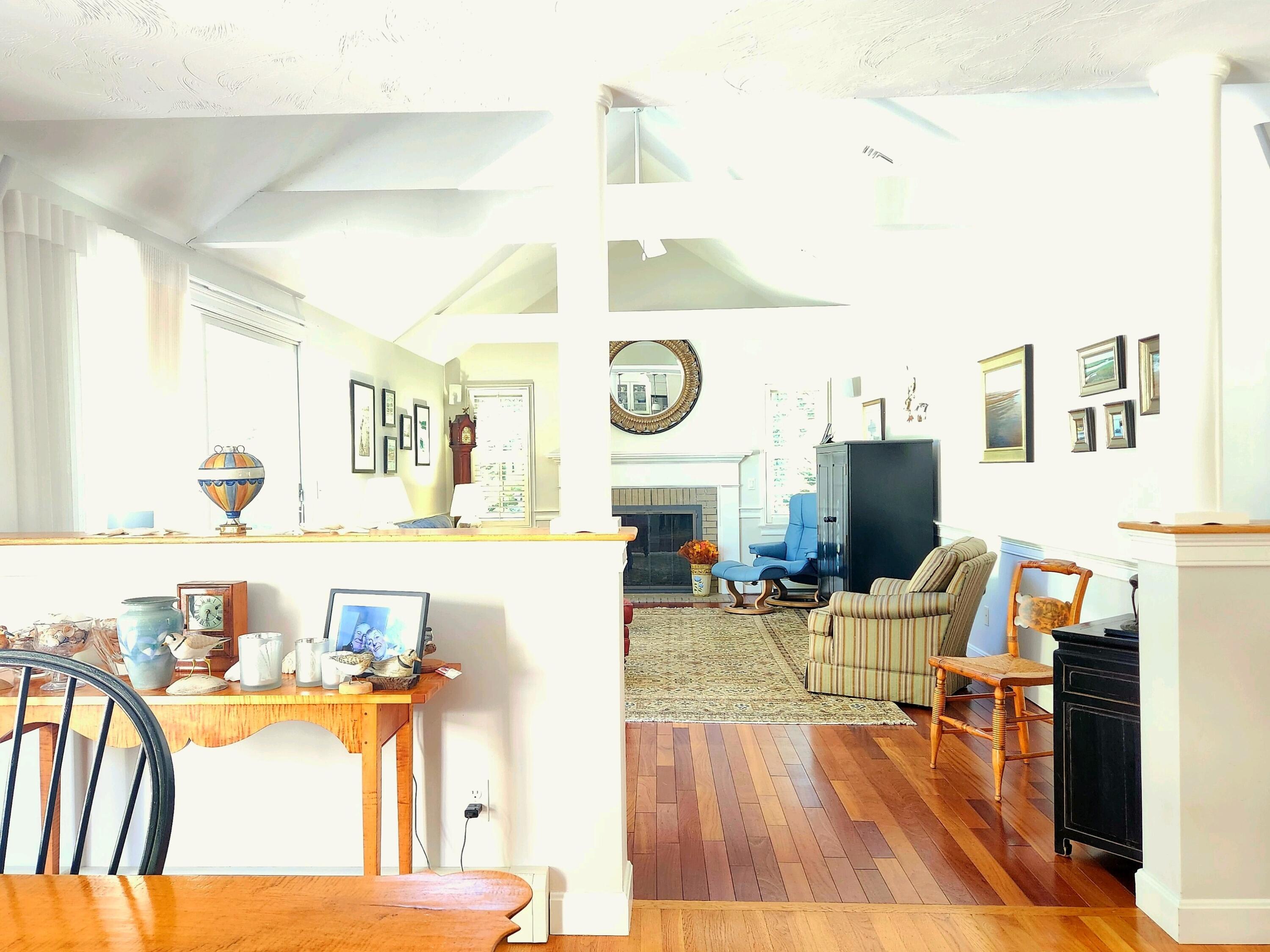 155 Far Fields Road Brewster, MA 02631 - Photo 5 of 40 a living room with fireplace furniture and a wooden floor