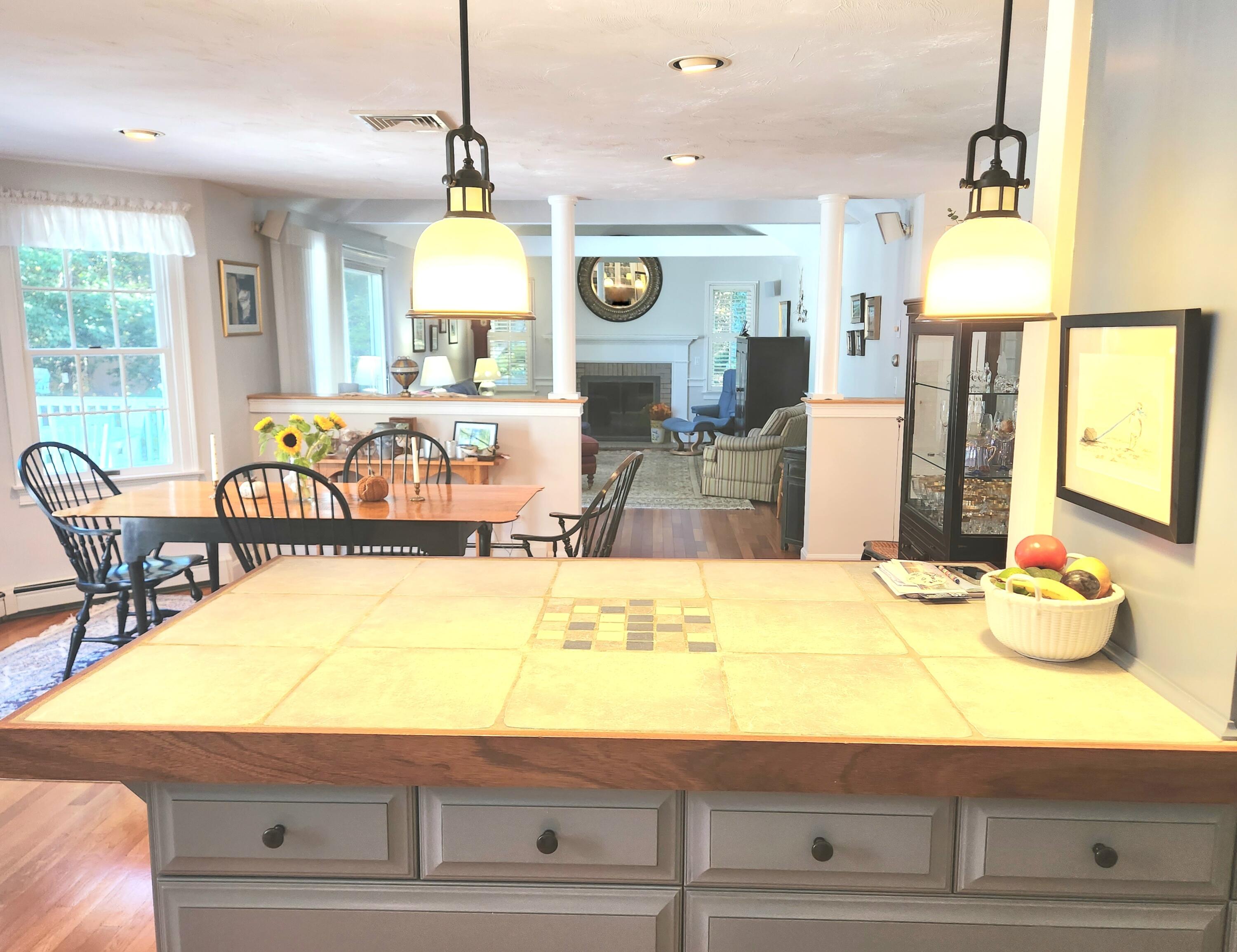 155 Far Fields Road Brewster, MA 02631 - Photo 9 of 40 a room with stainless steel appliances kitchen island granite countertop a table and chairs in it