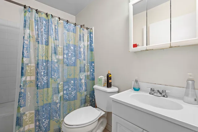 a bedroom with a bed closet and a large window