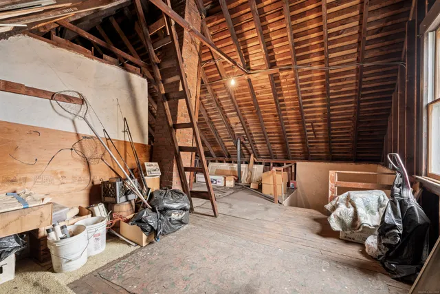 a bedroom with furniture and a window