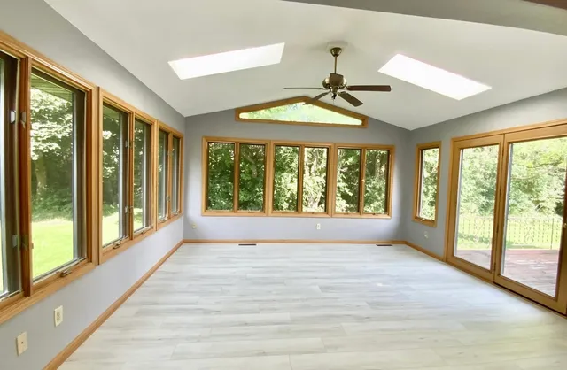 a view of room with window and a ceiling fan