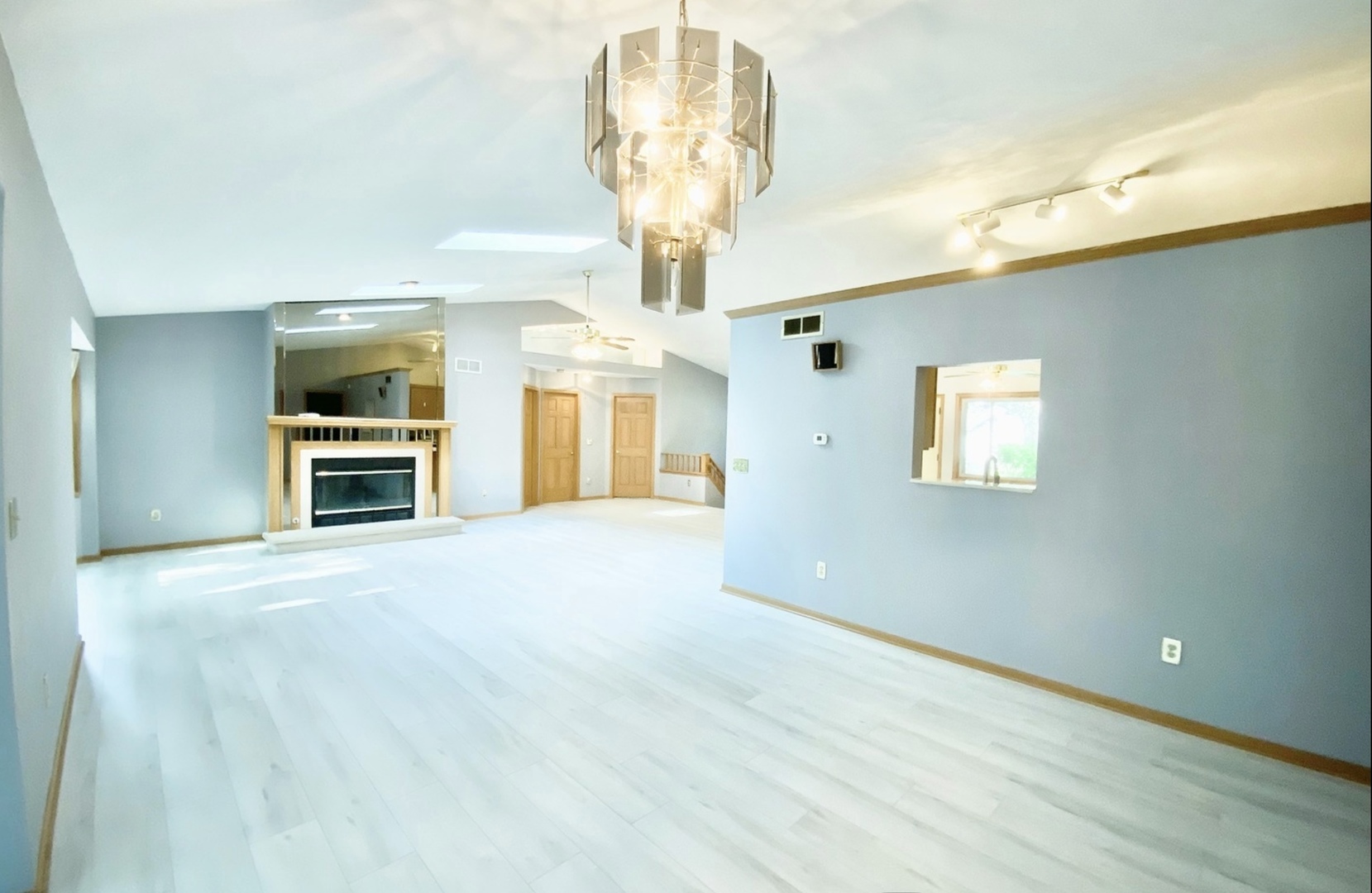 3121 Carefree Drive Rockford, IL 61114 - Photo 5 of 29 a view of a big room with windows and chandelier