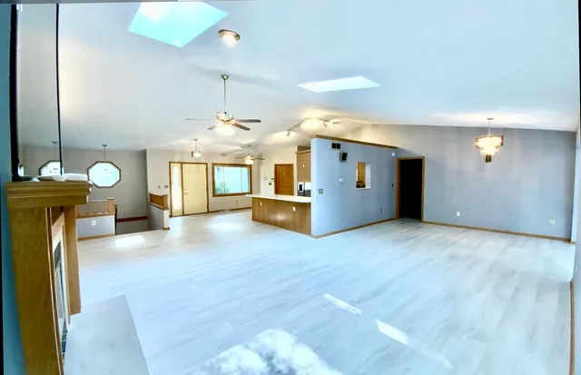 a kitchen with stainless steel appliances granite countertop a refrigerator a sink a stove a washer dryer and a refrigerator