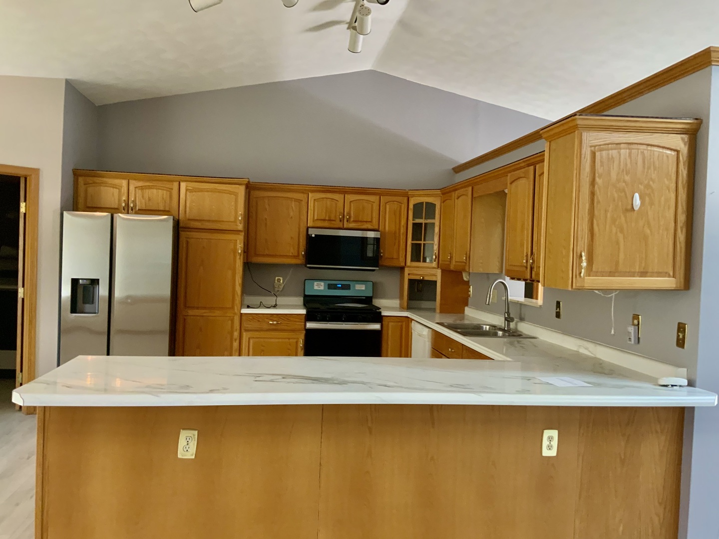 3121 Carefree Drive Rockford, IL 61114 - Photo 9 of 29 a kitchen with stainless steel appliances granite countertop a sink a stove and a refrigerator