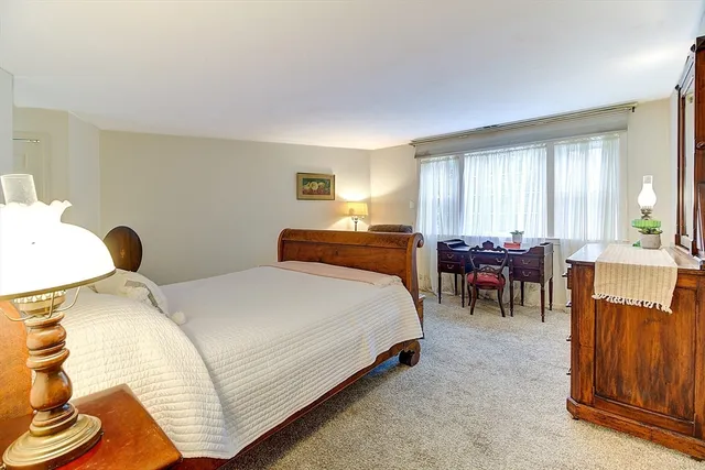 a bed room with a bed and a chandelier