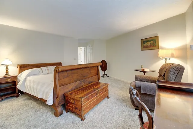 a bedroom with a bed and lamp