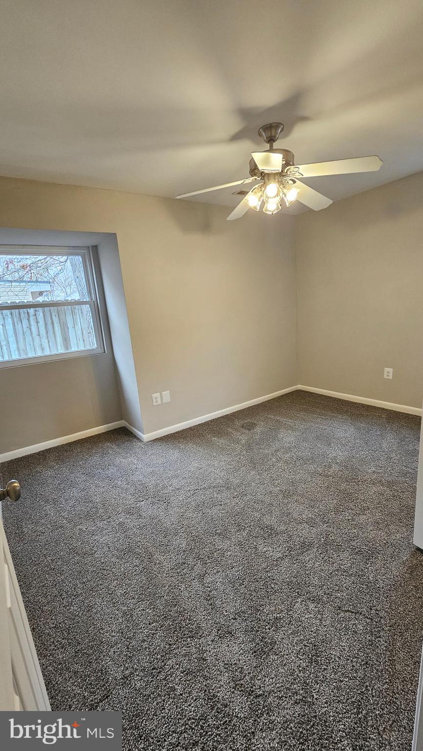 654 Emmett Place North Beach, MD 20714 - Photo 15 of 24 an empty room with a ceiling fan and window