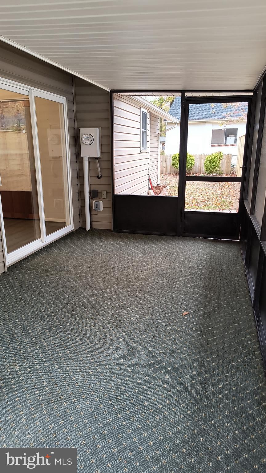 654 Emmett Place North Beach, MD 20714 - Photo 18 of 24 a view of an empty room with a fireplace and a large window