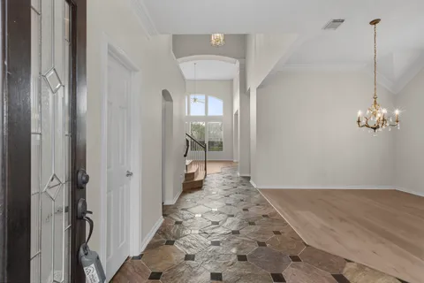 a kitchen with stainless steel appliances granite countertop a refrigerator a stove a sink and a oven