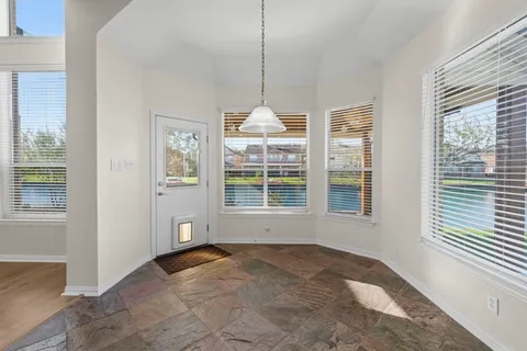 a kitchen with stainless steel appliances granite countertop a refrigerator a sink dishwasher a stove with wooden cabinets