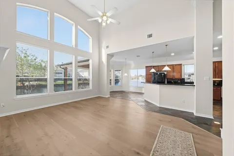 a view of an empty room with a kitchen