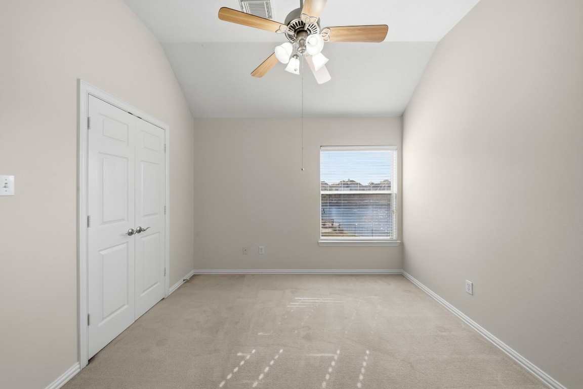 10103 Lazy Lagoon Houston, TX 77065 - Photo 27 of 50 an empty room with a chandelier fan and windows
