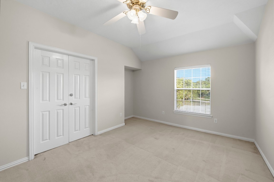 10103 Lazy Lagoon Houston, TX 77065 - Photo 28 of 50 an empty room with a window and a chandelier fan