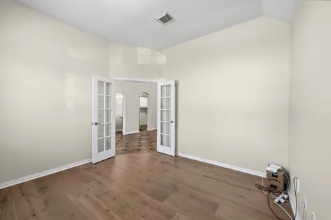 a view of a room with wooden floor