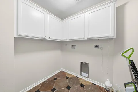 a front view of a house with a garden and lake view