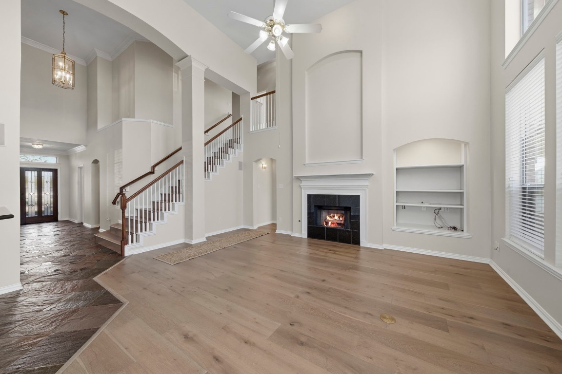 10103 Lazy Lagoon Houston, TX 77065 - Photo 4 of 50 a view of an empty room with wooden floor fireplace and a window
