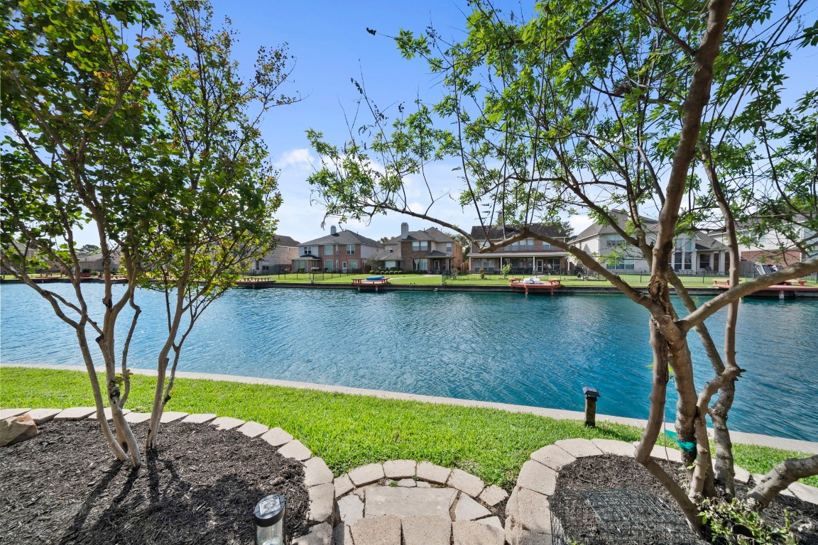 10103 Lazy Lagoon Houston, TX 77065 - Photo 41 of 50 a view of a lake with a yard
