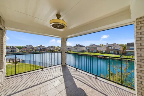 a view of a house with a yard from a balcony