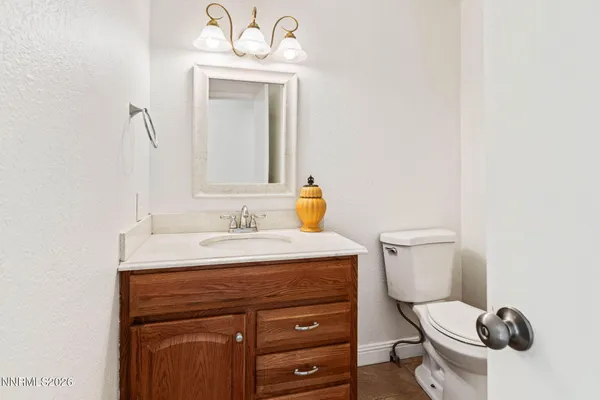 an empty room with fan and entrance