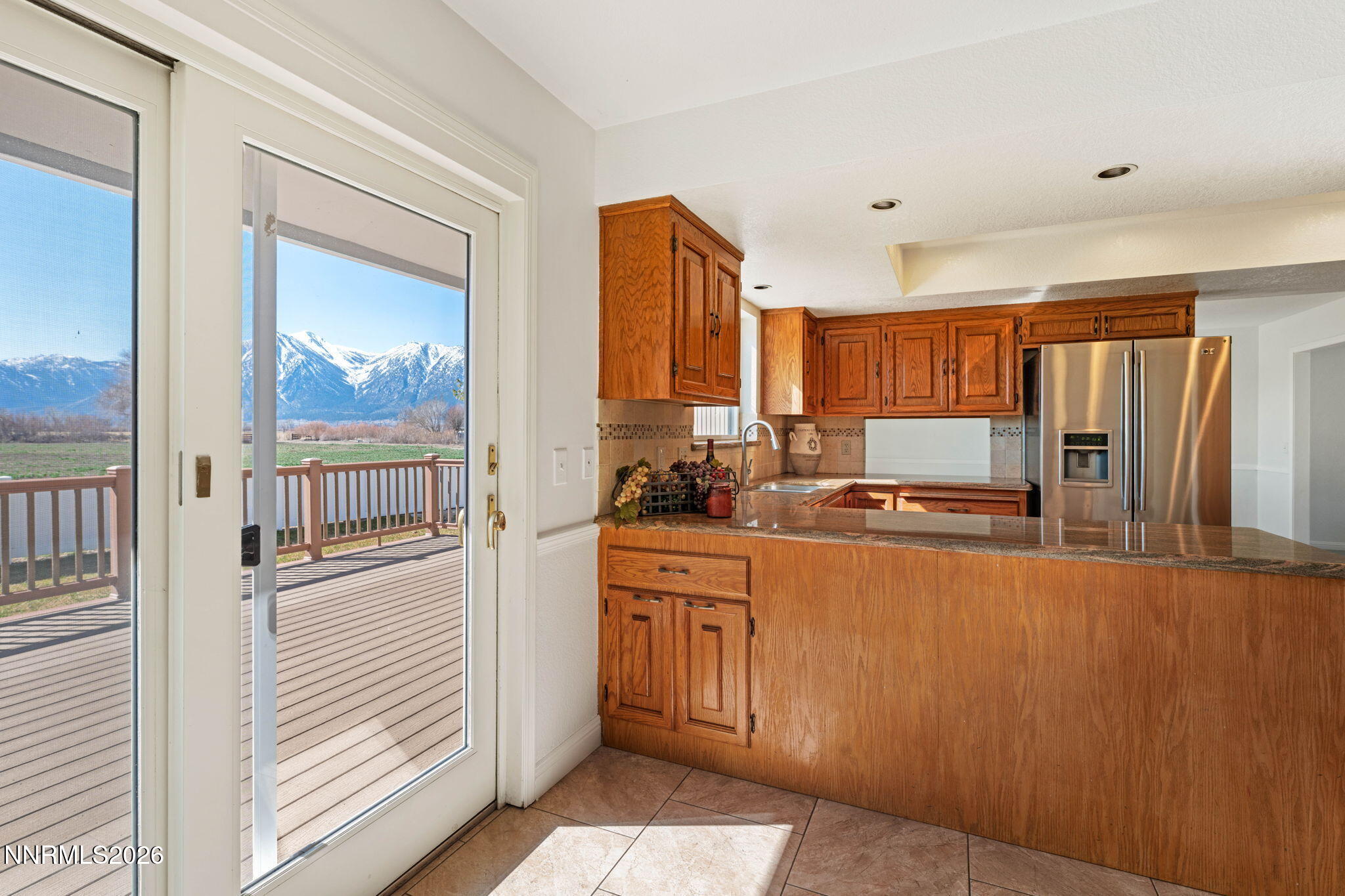 1663 Mackland Avenue Minden, NV 89423 - Photo 7 of 27 a kitchen with stainless steel appliances granite countertop a refrigerator and a stove top oven