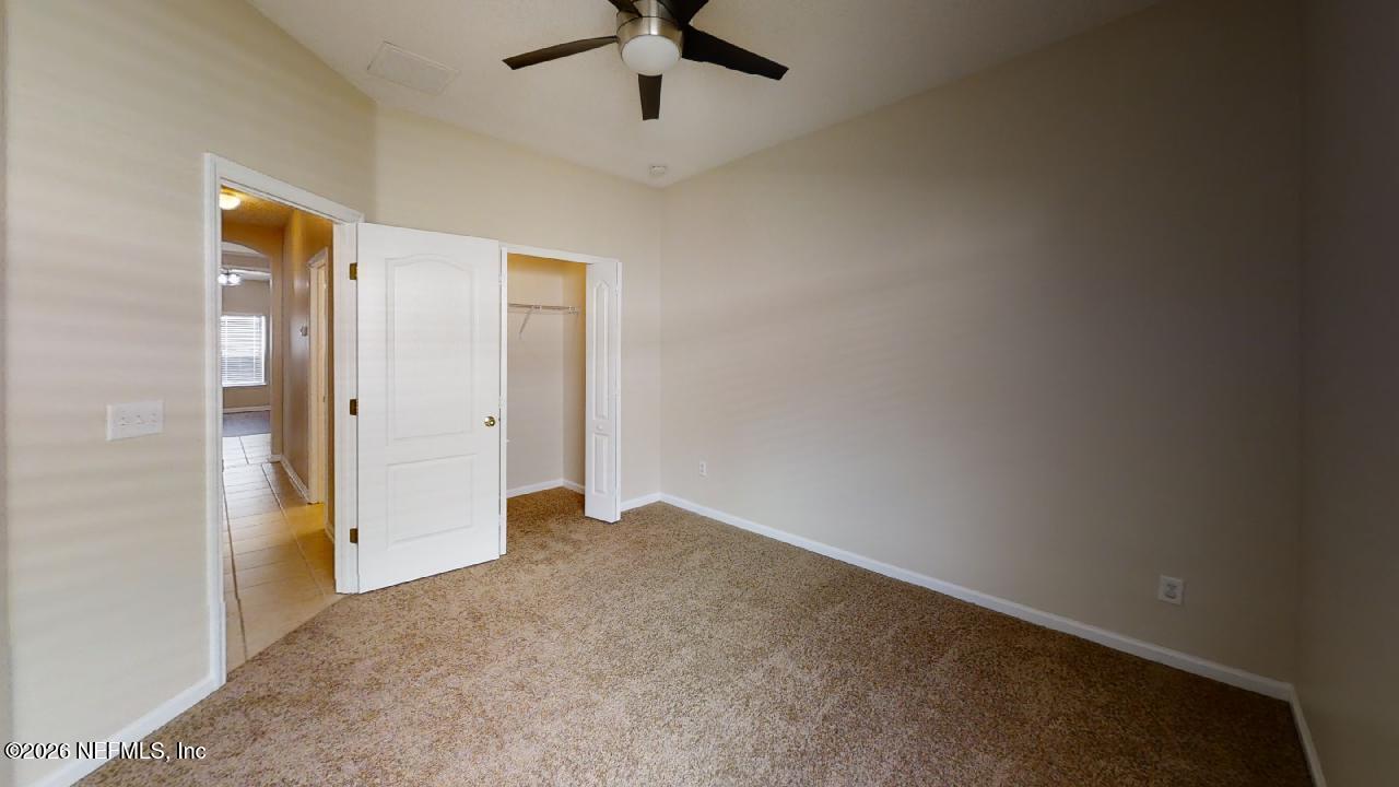 14454 Millhopper Road Jacksonville, FL 32258 - Photo 39 of 44 an empty room with fan and entrance