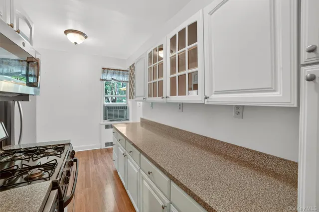 a kitchen with stainless steel appliances granite countertop a stove and a sink