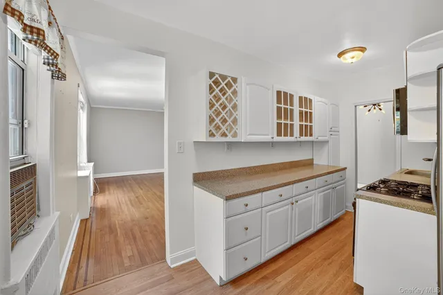 a kitchen with a cabinets and wooden floor
