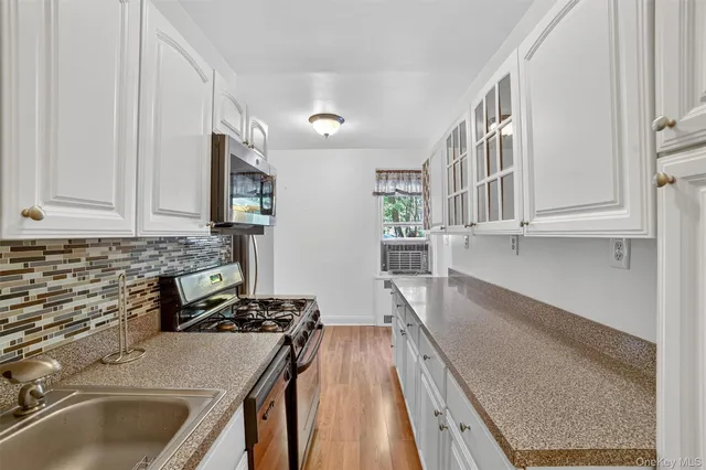 a kitchen with kitchen island a sink stove and cabinets