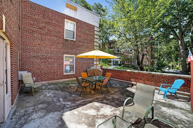 a backyard of a house with table and chairs