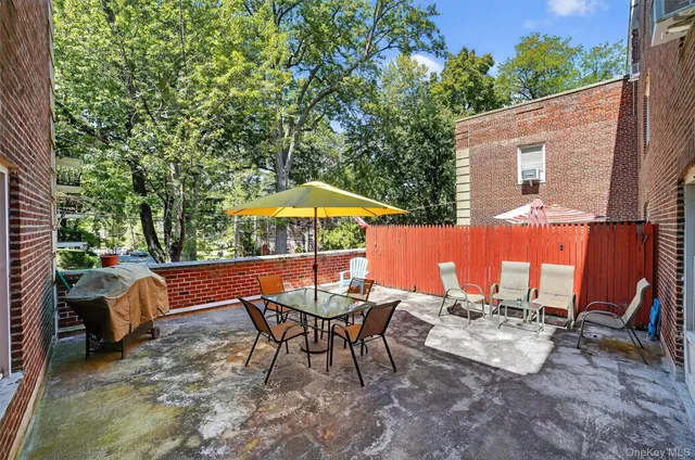 a view of backyard with outdoor seating and trees