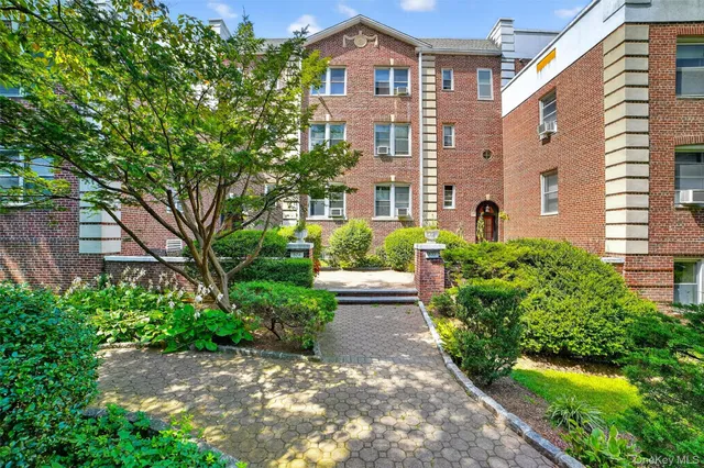 a view of a large brick building next to a yard