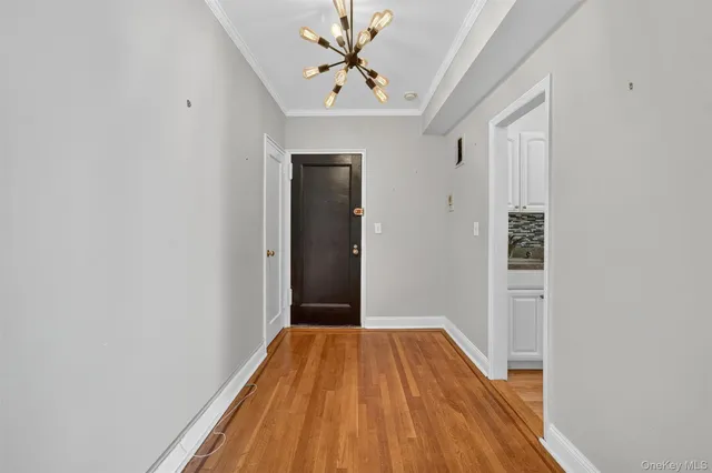a view of a bedroom with wooden floor and a ceiling fan