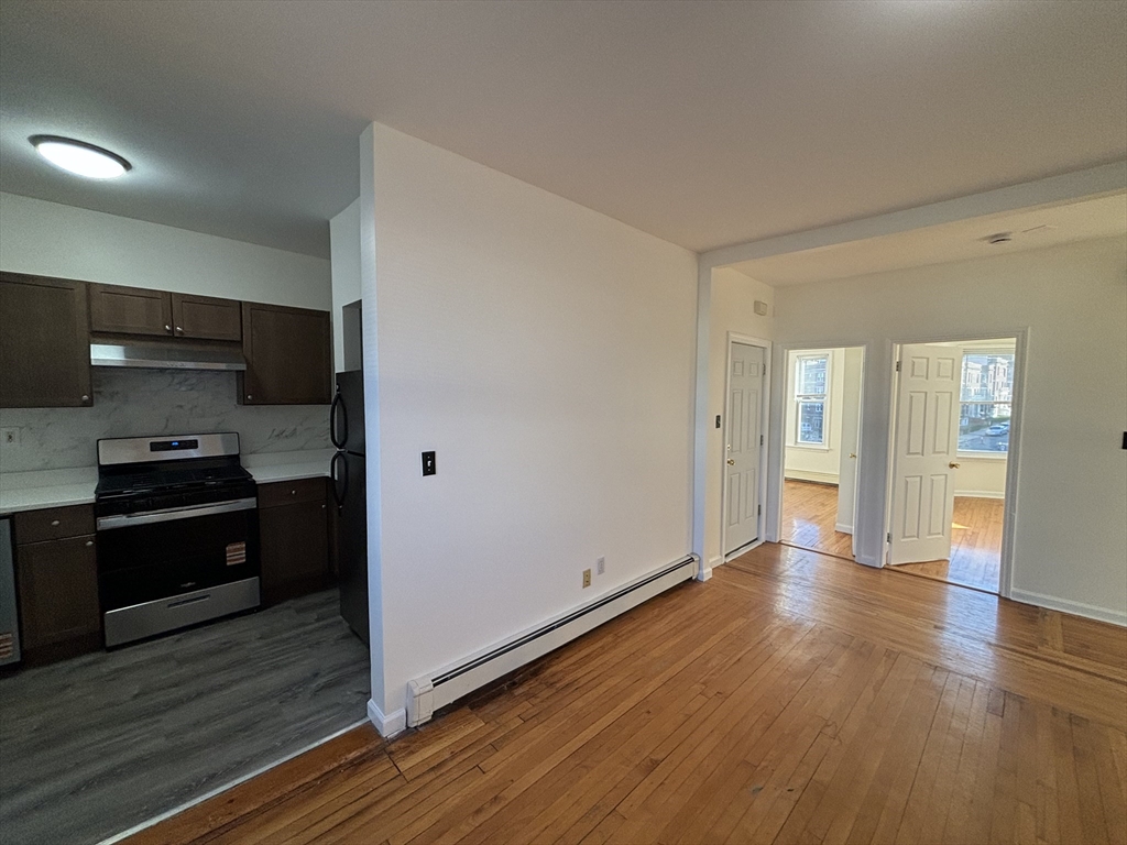 1371 Commonwealth Avenue, Unit 3 Boston, MA 02134 - Photo 5 of 8 a kitchen with a refrigerator and a stove top oven