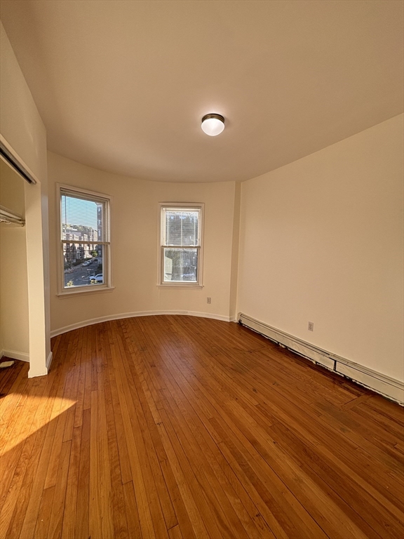1371 Commonwealth Avenue, Unit 3 Boston, MA 02134 - Photo 8 of 8 wooden floor in an empty room with a window